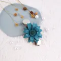 Close-up detail of handmade blue leather flower brooch shawl clip showing exquisite texture details. - Aqua