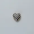 Black and white checkerboard heart detail shot of stylish cufflink and shirt accessory. - Black & White Checkered - Heart