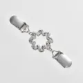 Rhinestone sweater clip detail view, sparkling crystals with secure metal duckbill clips. - Disc Twist Style