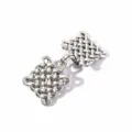 Close-up detail of vintage silver woven knot brooch, retro geometric shawl clip fastener. - Style 4