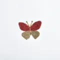 Detailed shot of the woven red butterfly cufflink accessory, showcasing fine texture. - Red and Brown Colorblock Style