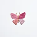 Close-up detail of a charming pink woven butterfly cufflink with gold tone metal details. - Pink Style