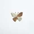 Close-up of the woven butterfly cufflink featuring gold metal and detailed paper cord wings. - White and Brown Colorblock Style