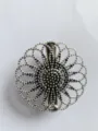 Close-up detail of vintage silver hollow carved flower brooch shawl clip ornament accessory. - Style 5