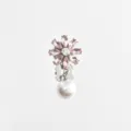 Close-up view of the exquisite pink crystal flower collar clip featuring a glowing pearl pendant. - Pink Rhinestone Flower + Silver Base