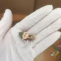 Close-up detail of the cute miniature character dust plug figurine, showing fine craftsmanship. - Side-lying Old Lady / Dustproof Plug