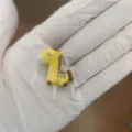 Cute yellow resin horse dust plug for 3.5mm headphone jack audio port closeup view - Fortune Horse / Yellow