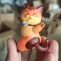 Close-up detail view of a cute cartoon orange cat figurine for creative desktop landscape decor. - No. 5 Orange Cat