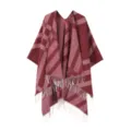 Detail view of the winter tassel poncho, featuring a classic plaid pattern and soft fabric. - Red