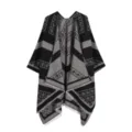 Close-up detail of the black and grey jacquard paisley patterned cape with stylish fringe trim. - Black