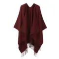 Detailed shot of the elegant burgundy fringe split knitted cape, soft texture, cozy layer. - Burgundy