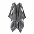 Detailed view of the women's grey striped poncho shawl with stylish fringe hem design. - Tops / Gray