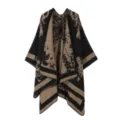 Detailed view of the black and khaki knitted poncho with floral pattern and striped hem. - Tops / Black Khaki