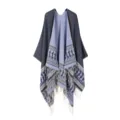 Detailed view of the cozy reversible knit poncho with elegant fringe and borders. - Navy Blue