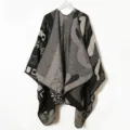 Detailed view of knitted black grey patterned cape shawl, soft texture geometric winter wear. - Black Shawl