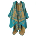 Detailed view of the teal and camel plaid knitted poncho, featuring soft draped design. - Striped Plaid - Green