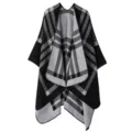 Detailed view of the black and grey plaid knitted poncho showing the soft texture and pattern. - Stripe Plaid Black