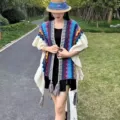 Ethnic style knitted wool shawl with colorful geometric wave patterns and tassel hem worn outdoors. - Blue