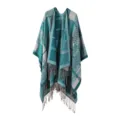 Detail view of the autumn winter women knitted plaid cape shawl with fringe and warm poncho design. - Cyan