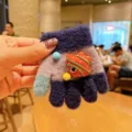 Close-up view of toddler knitted gloves, showing cute cartoon patch and cozy winter fabric. - One Size / Navy Blue