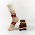 Detailed view of winter thick thermal Christmas socks with cute reindeer and snowflake pattern. - Beige Red