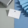 Detail shot of white multi-hole earring display cards on minimalist colored paper backdrop. - 6x4cm 6 Holes