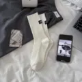 Solid white ribbed mid-calf socks for women, Korean style trendy casual hosiery with cute label. - White