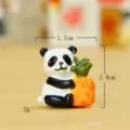 Cute miniature panda holding pineapple figurine detail shot, resin micro landscape bonsai decor. - Pineapple Panda