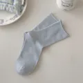 Light blue solid color ribbed crew socks for women, comfortable rolled edge breathable cotton style. - One Size / Sky Blue