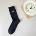 Black ribbed mid-calf cotton socks with stylish type embroidery, comfortable casual everyday wear. - One Size / Black