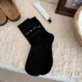 Black Korean style crew socks featuring cute white bows and heart patterns, cozy cotton. - Black