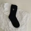 Women black mid-calf slouchy socks featuring a delicate white embroidered bow and contrast trim. - One Size / Black
