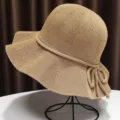 Detailed close-up of the stylish breathable knitted sun hat with wide brim and side bow tie. - Khaki