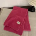 Close-up detail of cozy rose red knitted scarf with soft rib texture, warm winter accessory. - Rose Red