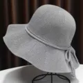 Detailed view of grey knit sun hat featuring fine woven texture and back bowknot. - Gray