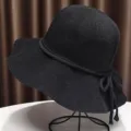 Black woven sun hat for women, breathable summer bucket hat with wide brim and cute bow tie. - Black