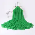 Green long scarf detail view, lightweight sheer fabric, elegant spring drapery and accessory. - Green