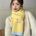 Detail view of a cozy yellow and blue color-block knitted scarf, soft winter accessory. - Contrast Base Knit - 5 Lemon Yellow