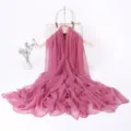 Detail view of a long pink chiffon scarf draped elegantly on hanger for detail display. - Deep Pink