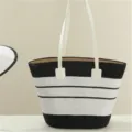 Close-up detail of the stylish black and white striped straw tote bag, exquisite woven texture. - Single Bag / Black