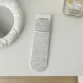 Light grey slouch socks for women, comfortable loose-fit knit mid-calf hosiery for daily wear. - Rice Grey