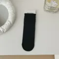 Black slouch socks for women, comfortable cotton crew socks, casual solid color hosiery variant. - Black