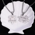 Gros plan détaillé d'un collier de pendentif puzzle de couple en acier avec gravure romantique. - Paire d'argent