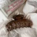 Close-up of a brown translucent resin hair claw clip with hollow design, elegant daily hair accessory. - Round Head Dragon Bone / Large Style / No.1 Transparent Brown