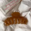 Detailed view of large amber acrylic hair claw clip showcasing hollow design and glossy texture. - Round Head Dragon Bone / Large Style / Amber Yellow