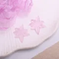 Pink sparkly star DIY hair accessory patch close up view, cute craft charm for girl crafts. - Hexagram