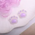 Close-up detail of cute purple resin cat paw cabochons, ideal for DIY hair accessories. - Bear Paw