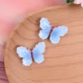 Colgantes mariposa de resina azul brillante, accesorios DIY para funda de teléfono y horquilla de pelo - Azul