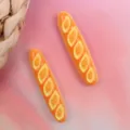 Resin baguette bread charm detail showing glossy texture and realistic baked miniature food look. - Style 7