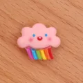 Close-up detail of cute pink cloud with colorful rainbow resin cabochon for DIY crafts. - Rainbow Rain